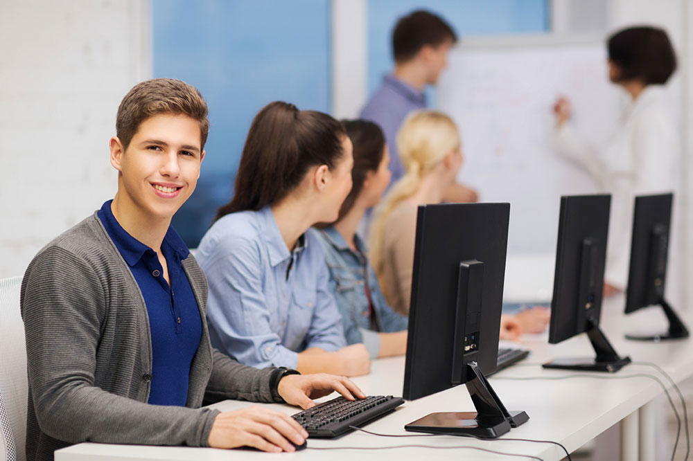 man in classroom using computer