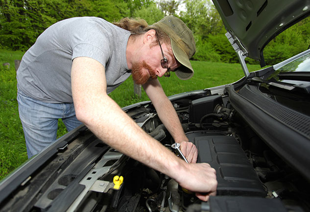 man working on his car
