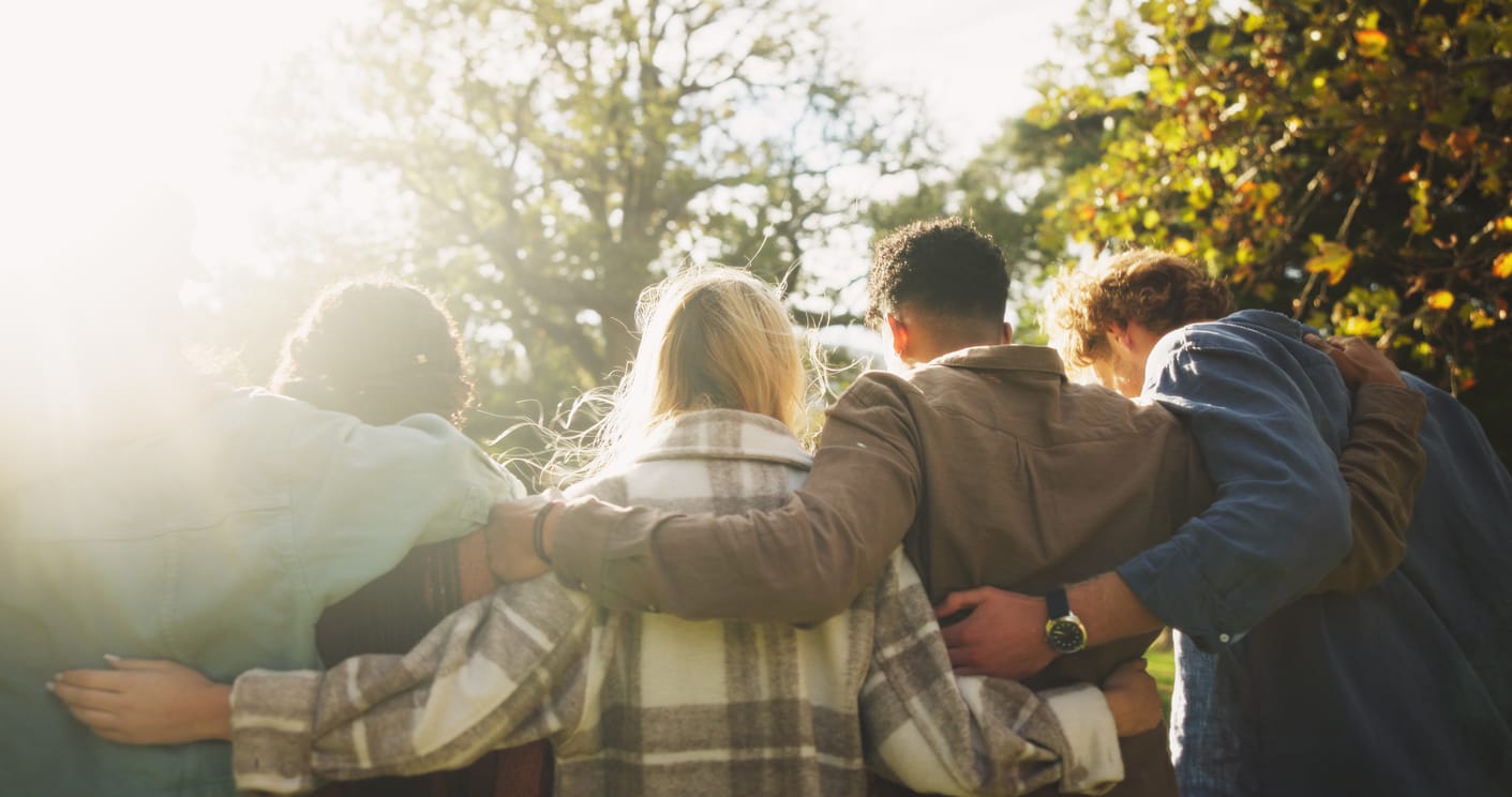 A group of students talking and supporting each other