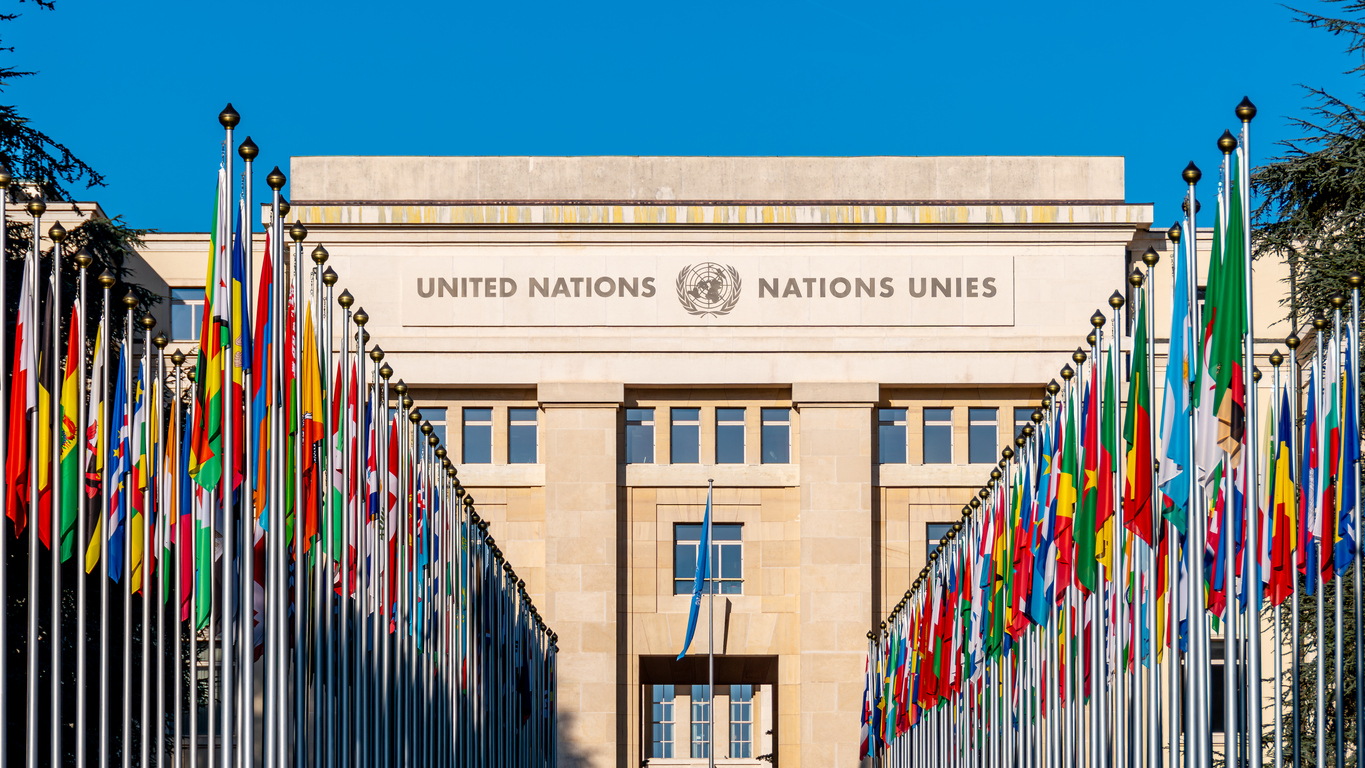 The United Nations building in Geneva with flags of member states.