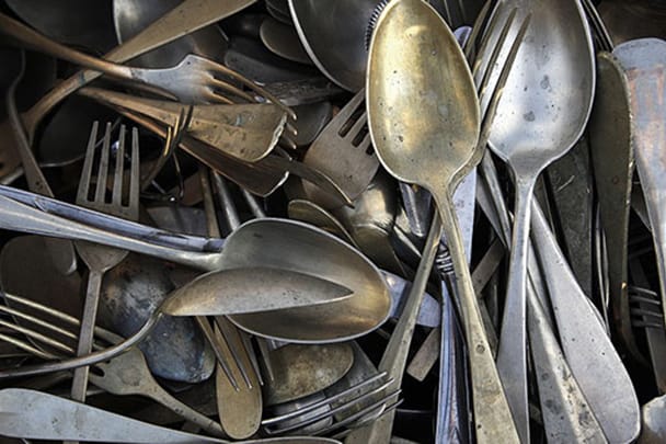dirty silver forks and spoons