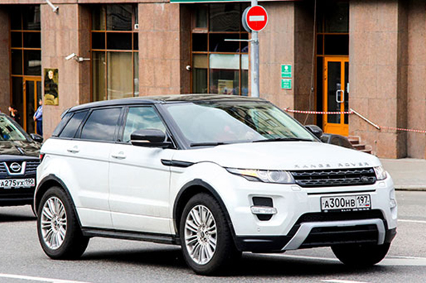 airplane next to a car in a airport