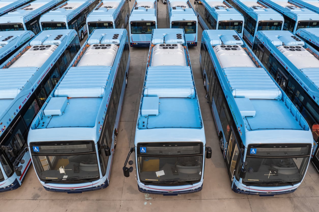 A modern electric city bus driving on a street.