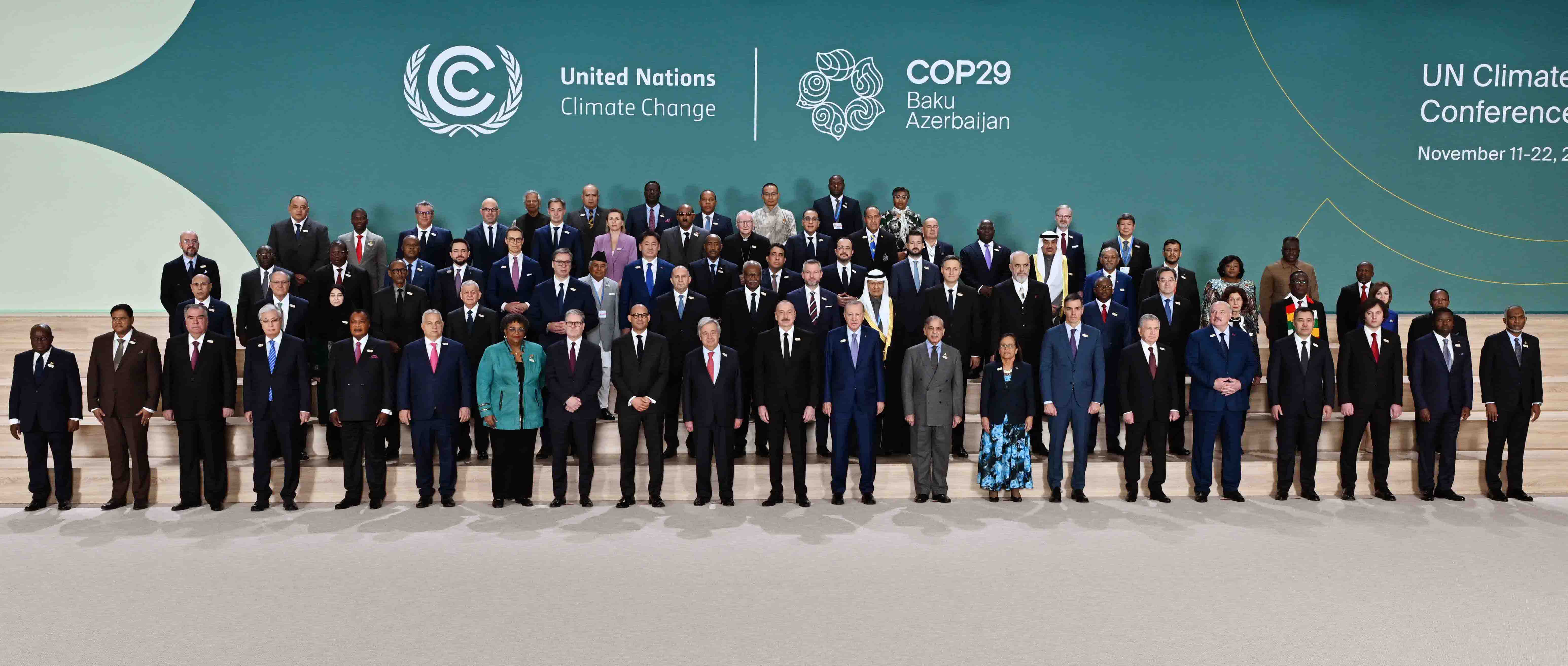 Leaders sitting around a large circular table at a global summit