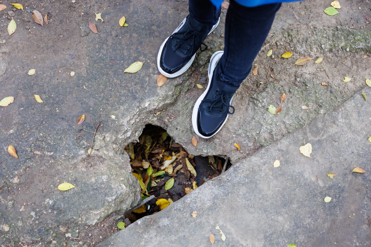 A clear photo of a pothole on a city street